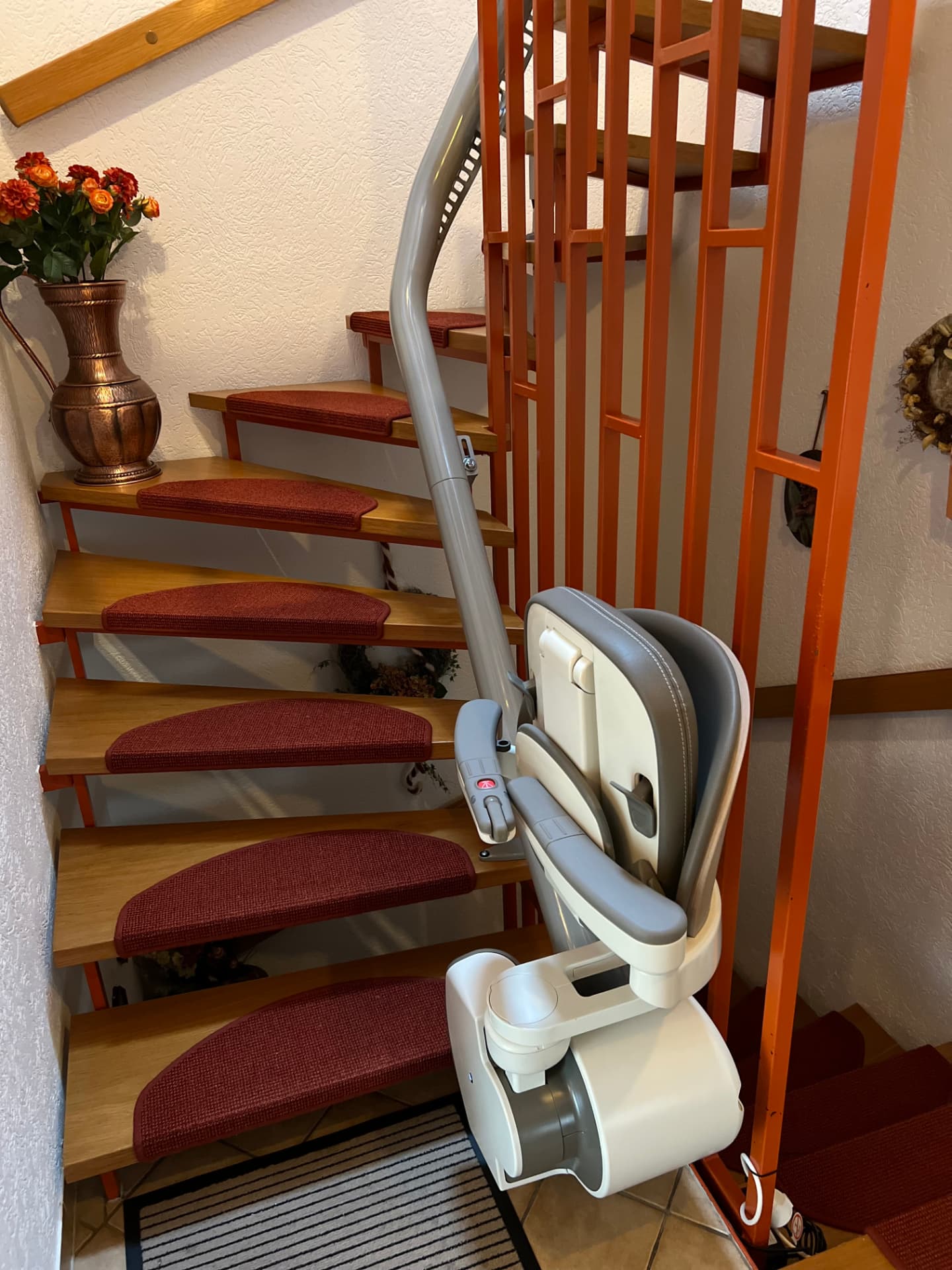 Treppenlift an offener Holztreppe, Schiene an der Wangenseite montiert
